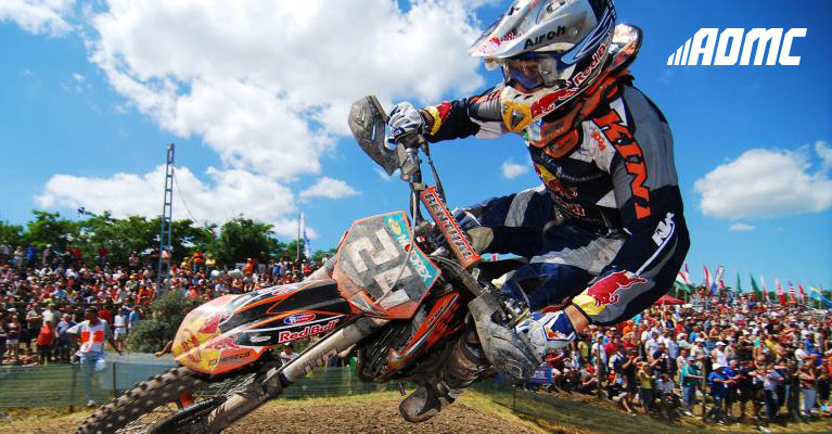 AOMC logo on an image of a motorcycle racer.